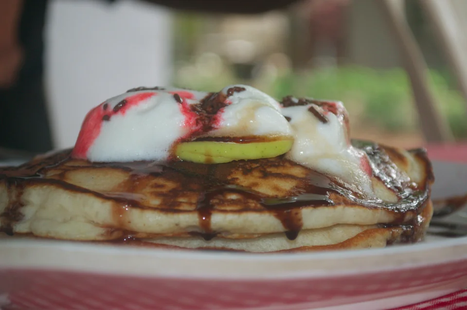 Pancake Hub’s fruit pancake topped with ice cream and chocolate syrup